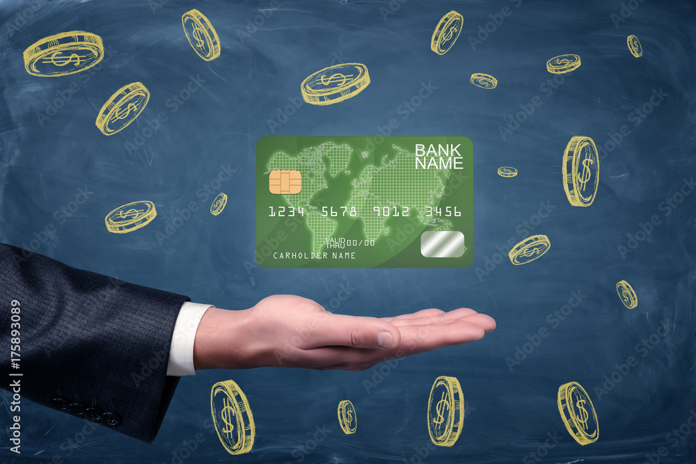 Poster an open businessman's palm with a green generic credit card hovering above it on blackboard backgrou