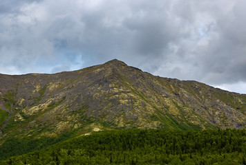 Fototapeta na wymiar Top mountain Khibiny in the form of a background of the cloudy sky.