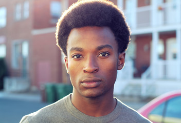 young african man portrait outside handsome guy standing in the street