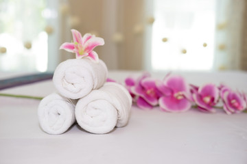 Fototapeta na wymiar beautiful pink orchid on white towel in spa salon.