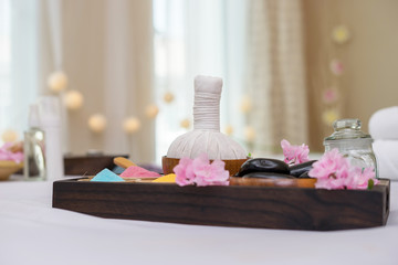Fototapeta na wymiar Essential oil, bath salt and black massage hot stones. Spa salon concept