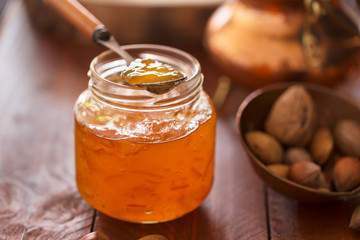 Peach jam in a transparent jar
