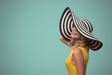 Pop art portrait of beautiful woman in hat. Blue background.