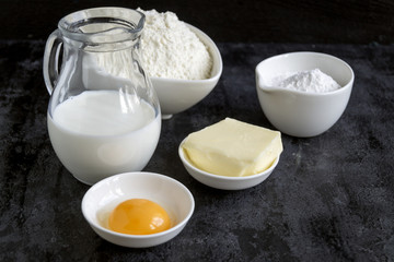 Ingredients for buns on a black background.