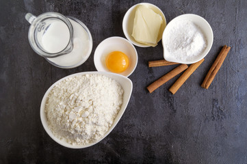 Ingredients for buns on a black background.