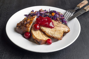 Pork roast with cranberry sauce and red cabbage.