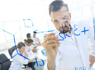 close up of a Man scientist working with formulas