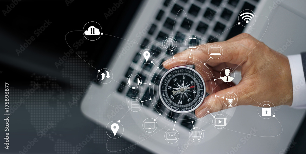 Poster businessman with a compass holding in hand on laptop and icon customer network connection on screen,