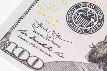 The figure is a hundred on the corner of the US money bill. Macro.