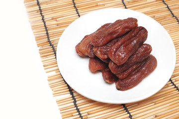 Natural Solar Dried Banana on dish isolated white background.