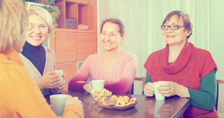 Senior female friends drinking coffee