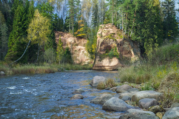 River Amta, autumn, red rocks and sunny day. Latvia. 2011