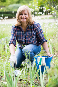 woman planting cornflag