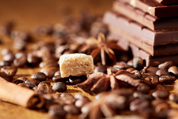 Aroma coffee chocolate cookies and spices on the wooden table. Dark wooden background. Top view. Close. Closeup.