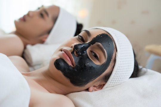 Beautiful woman getting facial mask at beauty salon.