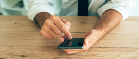 Smartphone in hands of successful businessman