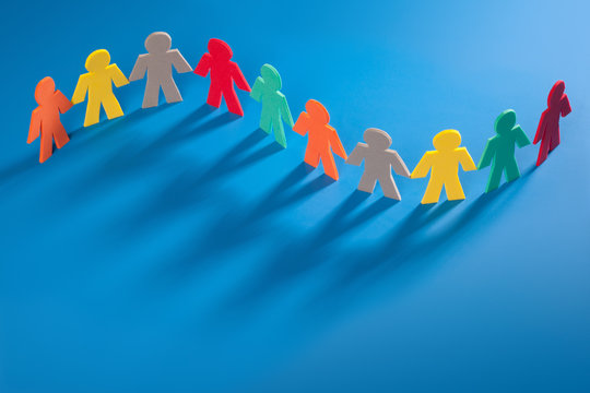Group of Multi Colored Little People On Blue Background in a nice curvy line