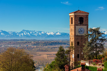 Old campanile and autumnal landscape view in Italy.