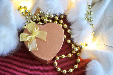 Golden Heart Shape Present Box on Red and White Background