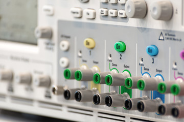 Fragment of a modern digital oscilloscope. Connector and regulator panel.