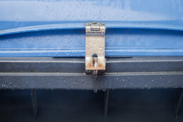 Blue dustbin with padlock