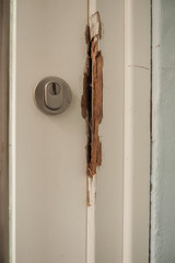 Damaged door frame after a burglary