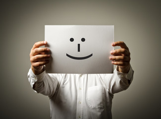 Man is holding white paper with smile. Happy concept.