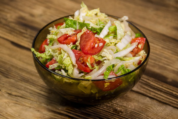 Fresh vegetable salad on wooden table