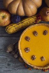 Naklejka na ściany i meble Autumn background. Homemade Pumpkin Pie for Thanksgiving Ready to Eat. Design mock up