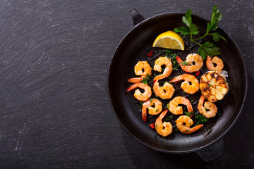 pan of grilled shrimps on a dark table