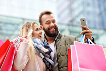 Happy couple shopping in the city