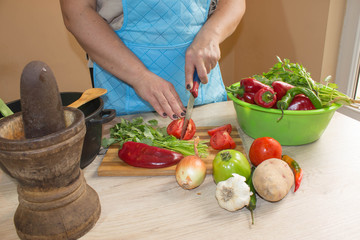 woman hands cutting vegetables on kitchen blackboard. Healthy food. Woman preparing vegetables, cooking healthy meal in the kitchen