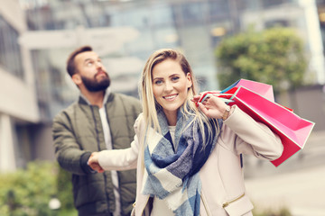 Happy couple shopping in the city