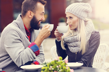 Happy adult couple dating in cafe