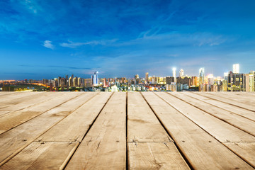 Obraz premium empty wooden floor with cityscape of hangzhou at twilight