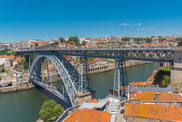 Fototapeta na wymiar Porto, Portugal, panorama of Dom Luis bridge, the river Douro and tiles roofs 