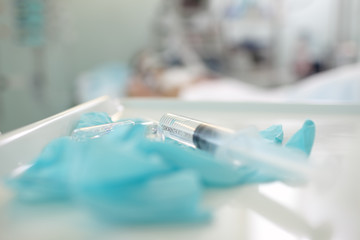 Medical background with lying patient and tools.