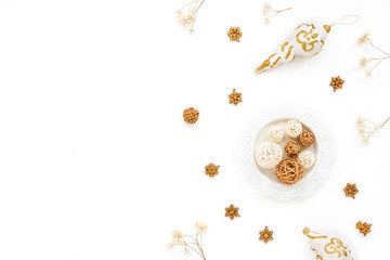 White and golden christmas decorations on white background. Flat lay, top view, copy space