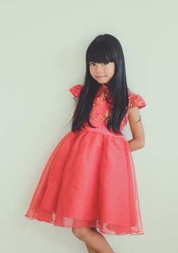 A cute asian kid girl wearing red Chinese dress for Chinese New year