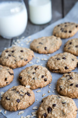 homemade oatmeal cookies with chocolate on an old wooden background