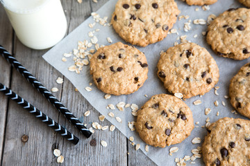 homemade oatmeal cookies with chocolate on an old wooden background