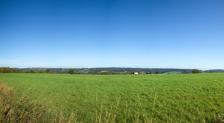 field with blue sky panorama