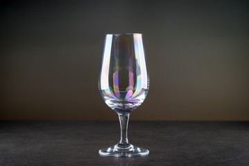 Pouring red wine into the glass against rustic background