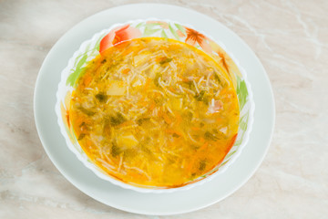 Homemade soup on a marble table closeup