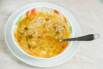 Homemade soup on a marble table closeup