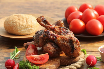 Grilled chicken legs on cutting board.Rustic dinner background