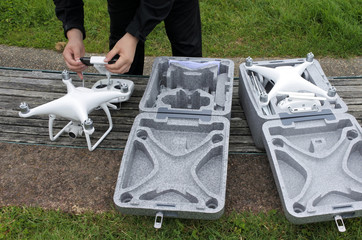 Person prepares two drones for a flight