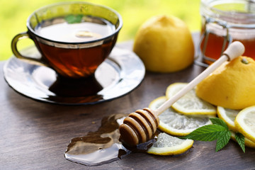 Fresh honey with a cup of black tea