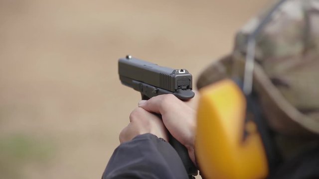 1080 Tactical shooting range, man shoots a pistol on the target.