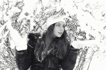 Beautiful girl in winter snowy monochrome